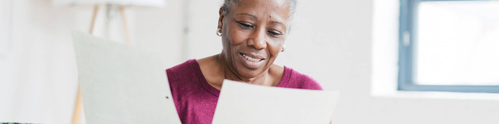 Senior woman holding documents in her hands